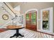 Spacious home foyer with hardwood floors, Zebra-print rug, and front door with sidelight windows at 560 Indigo Dr, Roswell, GA 30075