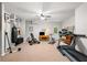 Spacious home gym featuring exercise equipment, a punching bag, carpet flooring, and ample lighting at 560 Indigo Dr, Roswell, GA 30075