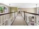 Hallway with wood railings overlooking the living room at 560 Indigo Dr, Roswell, GA 30075