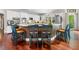 Kitchen with wooden floors, white cabinets, granite countertop island with barstool seating at 560 Indigo Dr, Roswell, GA 30075
