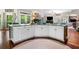 Large kitchen island with marble countertop, white cabinets, and natural light at 560 Indigo Dr, Roswell, GA 30075