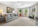 Bright living room with a bay window, comfortable couch and decor offers a cozy space at 560 Indigo Dr, Roswell, GA 30075