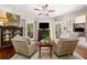 Cozy living room with a fireplace, hardwood floors, and comfortable seating at 560 Indigo Dr, Roswell, GA 30075