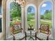 Cozy sitting area showcasing chairs and a picturesque view from the arched windows at 560 Indigo Dr, Roswell, GA 30075