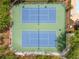 Aerial view of community tennis courts surrounded by beautiful landscaping and shade trees, providing a great recreational space at 560 Indigo Dr, Roswell, GA 30075