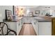 Basement wet bar featuring modern white cabinets, counter seating, and a sink offers a functional entertaining space at 560 Indigo Dr, Roswell, GA 30075