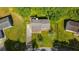 A tranquil home is centered on a lush green lot with mature trees and a long driveway at 6182 Silver Spur Dr, Lithonia, GA 30058
