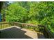 Private deck overlooking lush green foliage offers serene outdoor space at 6182 Silver Spur Dr, Lithonia, GA 30058