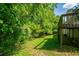 Landscaped backyard featuring lush greenery with the deck visible at 6182 Silver Spur Dr, Lithonia, GA 30058