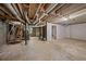 Unfinished basement features concrete flooring and exposed overhead pipes at 6182 Silver Spur Dr, Lithonia, GA 30058