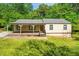 Charming single-story home with a welcoming front porch and well-maintained lawn at 6182 Silver Spur Dr, Lithonia, GA 30058