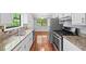 Well-lit kitchen featuring stainless steel appliances, granite countertops, and white cabinetry at 6182 Silver Spur Dr, Lithonia, GA 30058