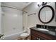 Well-maintained bathroom with tiled shower, vanity, and round mirror at 8106 Santa Fe Pkwy, Atlanta, GA 30350