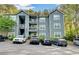Three-story condo building with gray siding, balconies and well-maintained landscaping at 8106 Santa Fe Pkwy, Atlanta, GA 30350