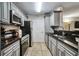 Galley kitchen with granite countertops and stainless steel appliances at 8106 Santa Fe Pkwy, Atlanta, GA 30350
