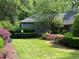 Immaculate landscaping surrounding a community building with colorful bushes and green grass at 8106 Santa Fe Pkwy, Atlanta, GA 30350
