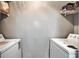 Functional laundry room with washer, dryer, and shelving at 8106 Santa Fe Pkwy, Atlanta, GA 30350