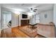 Sun-filled living room boasts hardwood floors, ceiling fan, and sliding glass doors at 8106 Santa Fe Pkwy, Atlanta, GA 30350