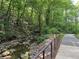 Well-maintained walking trail bordering a serene stream within a lush wooded area at 8106 Santa Fe Pkwy, Atlanta, GA 30350