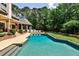 Beautiful backyard with pool, putting green, hot tub, covered patio, and ample space for entertaining at 1114 Waterford Green Pt, Marietta, GA 30068