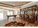 Finished basement with a pool table, wet bar, tile floors, recessed ceiling lights and access to the exterior at 1114 Waterford Green Pt, Marietta, GA 30068