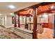 Basement kitchen featuring a breakfast bar, oven, microwave, wood cabinets and ceiling and a small seating area at 1114 Waterford Green Pt, Marietta, GA 30068