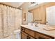 This bathroom has a white vanity, a framed mirror, a shower with a patterned shower curtain, and tile flooring at 1114 Waterford Green Pt, Marietta, GA 30068