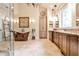 Bright bathroom with a copper soaking tub, chandelier, and custom cabinets providing ample storage at 1114 Waterford Green Pt, Marietta, GA 30068