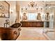 Elegant bathroom featuring a copper soaking tub and a spacious vanity with lots of storage at 1114 Waterford Green Pt, Marietta, GA 30068