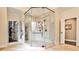 Glass enclosed shower and view into a closet in this neutral toned bathroom at 1114 Waterford Green Pt, Marietta, GA 30068