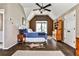 Cozy bedroom featuring hardwood floors, a vaulted ceiling, and a large window at 1114 Waterford Green Pt, Marietta, GA 30068