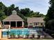 Community pool with bathhouse and shaded seating, surrounded by trees at 1114 Waterford Green Pt, Marietta, GA 30068