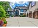 Stunning home features a large driveway, three-car garage, and professionally landscaped yard at 1114 Waterford Green Pt, Marietta, GA 30068