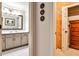 Hallway view of a white bathroom vanity with a walk-in closet and chest of drawers at 1114 Waterford Green Pt, Marietta, GA 30068