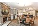 Eat-in kitchen with stone fireplace, breakfast table, island, and stainless steel appliances at 1114 Waterford Green Pt, Marietta, GA 30068