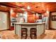 Elegant kitchen featuring stone accent wall, brick arch, wooden ceiling, bar seating and stainless steel appliances at 1114 Waterford Green Pt, Marietta, GA 30068