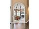 Living room view through the arched doorway, featuring a fireplace and ample natural light at 1114 Waterford Green Pt, Marietta, GA 30068