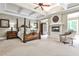 Spacious main bedroom with a tray ceiling, fireplace, sitting area, and plenty of natural light at 1114 Waterford Green Pt, Marietta, GA 30068