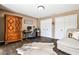 This office includes a wooden wardrobe, desk, chair, dark wood floor, and a white and gray cow skin rug at 1114 Waterford Green Pt, Marietta, GA 30068