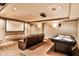 Recreation room featuring a projector screen, leather sofa, air hockey table, and recessed lighting at 1114 Waterford Green Pt, Marietta, GA 30068