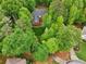 Aerial view of a private, wooded property with mature trees and lush landscaping provides privacy at 1275 Smokehouse Trl, Cumming, GA 30041