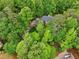 Aerial view of a private home surrounded by lush landscaping provides a peaceful setting at 1275 Smokehouse Trl, Cumming, GA 30041