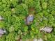 Aerial view of the property including deck and fenced yard surrounded by mature trees at 1275 Smokehouse Trl, Cumming, GA 30041
