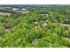 Aerial view showcases a home in a neighborhood surrounded by mature landscaping at 1275 Smokehouse Trl, Cumming, GA 30041