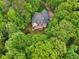 Aerial view of this home featuring a large deck, backyard, and mature landscaping at 1275 Smokehouse Trl, Cumming, GA 30041