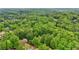 Secluded brick home nestled amongst lush greenery and mature trees, ensuring privacy at 1275 Smokehouse Trl, Cumming, GA 30041