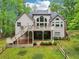 Charming home featuring a large back deck, backyard, and mature landscaping, creating an inviting outdoor space at 1275 Smokehouse Trl, Cumming, GA 30041