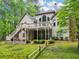 Expansive backyard featuring a spacious deck, mature trees, and lush landscaping, perfect for outdoor living at 1275 Smokehouse Trl, Cumming, GA 30041
