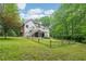 Large backyard with green grass, wooden fence, and mature trees offering a serene and private outdoor setting at 1275 Smokehouse Trl, Cumming, GA 30041