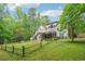 Expansive backyard with a lush lawn, wooden fence, and mature trees providing a private outdoor space at 1275 Smokehouse Trl, Cumming, GA 30041
